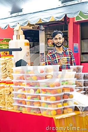 Local businessman is selling Indian assorted sweets or mithai during Deepavali Editorial Stock Photo