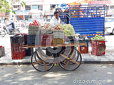 Local dealer selling a sale in Lari on footpath in the summer Editorial Stock Photo
