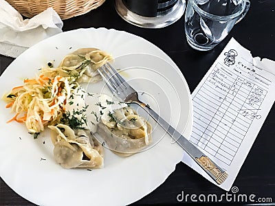 Local dumpling Manti and bill in restaurant Editorial Stock Photo