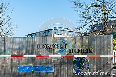 Local European School Europaschule closed due to global corona virus, COVID-19 pandemic. Logo with barrier tape. Editorial Stock Photo