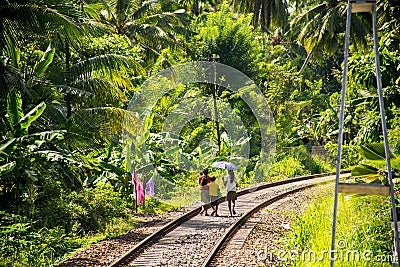 Local family in sri lanka walking on railway tracks Editorial Stock Photo