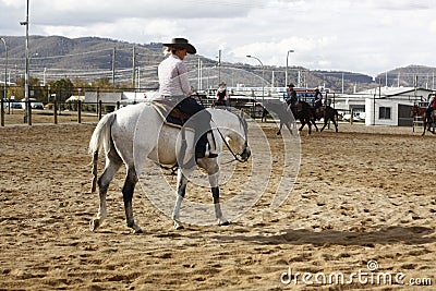 Local farmers riding their quaterhorses, competing at a cutting horse, futurity Editorial Stock Photo