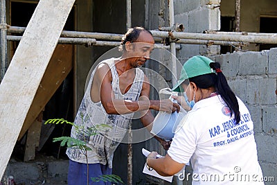 Local government workers distribute relief goods during the Covid 19 virus outbreak Editorial Stock Photo