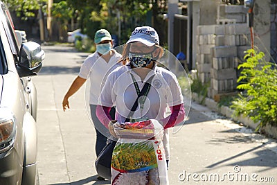 Local government workers distribute relief goods during the Covid 19 virus outbreak Editorial Stock Photo