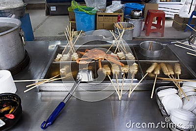 Local hawker stall traditional korean gourmet on street food bazaar market oden teokbokki and Eomuk with taraba king crab for Stock Photo