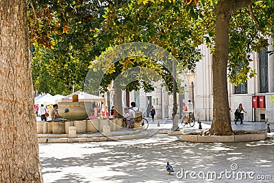 Local Italians and families relax by fountains and under trees in the Piazza della Vittoria in Brindisi, Italy. Editorial Stock Photo