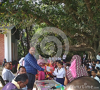 A local level political leader distributing prizes to laborious students of a school Editorial Stock Photo