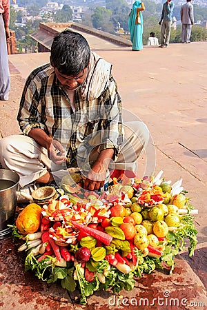 Local man selling food outside Buland Darwasa Victory Gate lea Editorial Stock Photo
