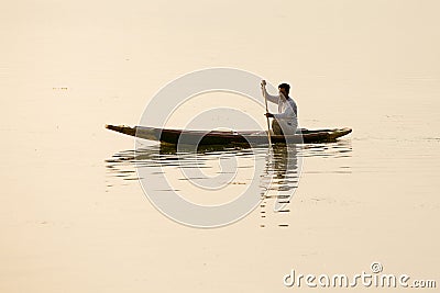 Local man in small boat for transportation in the lake of Srinagar, Jammu and Kashmir state, India Editorial Stock Photo