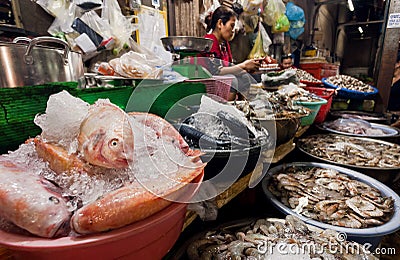 Local market with huge choice of seafood, crabs, fish, shrimps for customers in asian city Editorial Stock Photo