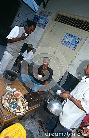 Local men hanging out at street side stall, Zanzibar Editorial Stock Photo