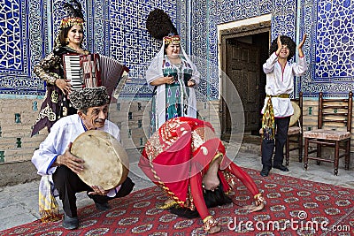 Local musicians playing musical instruments, singing and dancing, in Khiva, Uzbekistan Editorial Stock Photo