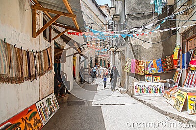 Local people on a street in Stone Town. Stone Town is the old part of Zanzibar City, the capital of Zanzibar, Tanzania Editorial Stock Photo