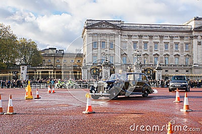 Local people and tourist greet and welcome vintage Royal family car vehicles leave the Buckingham palace Editorial Stock Photo