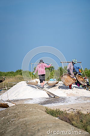 Local people working on the salt flats in Phetchaburi, Thailand, Asia Editorial Stock Photo