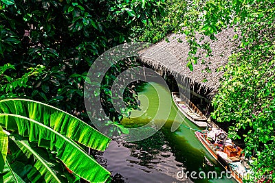 Riverside Tranquility: Embracing Serenity in a Thatched-Roof Floating House Stock Photo