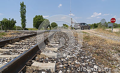 Local railway with the asphalt road crossing in a countryside, Afyonkarahisar, Turkey Stock Photo