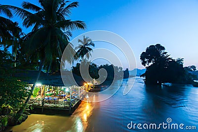 Local restaurant on the Mekong Riverside at dusk Stock Photo