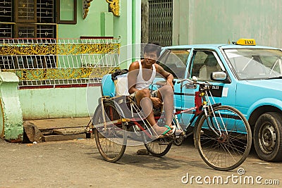 Local taxi tricycle driver Editorial Stock Photo