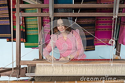 Local Thai weaver crafting traditional silk on a loom at Ratchaburi, Thailand Editorial Stock Photo