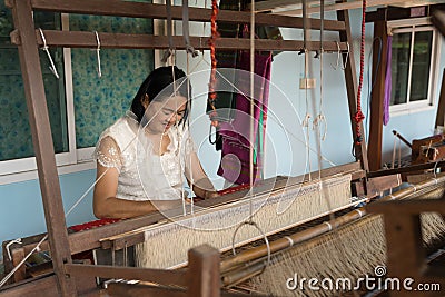 Local Thai weaver crafting traditional silk on a loom Editorial Stock Photo