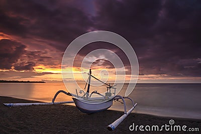 Local traditional boat under the burning sky Stock Photo