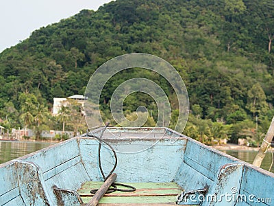 Local traditional Thai wooden long tail boat of fishermen heads toward the coast of Island Stock Photo