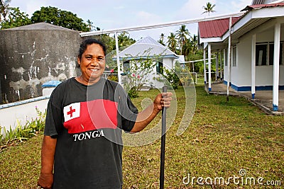 Local woman cleaning church yard, Ofu island, Tonga Editorial Stock Photo