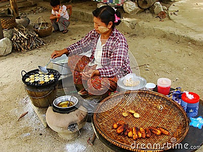 Local woman cooking in the street of Mingun, Mandalay, Myanmar Editorial Stock Photo