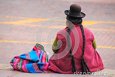 Local woman sitting at Plaza de Armas in Cusco, Peru Editorial Stock Photo