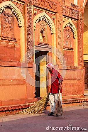 Local worker sweeping courtyard of Jahangiri Mahal in Agra Fort, Uttar Pradesh, India Editorial Stock Photo