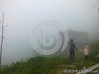 Locals in Dumanli Village in front of their house in foggy weather, Gumushane, Turkey. Editorial Stock Photo