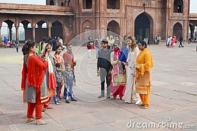 Locals at Jama Masjid taking pictures with foreign tourist Editorial Stock Photo