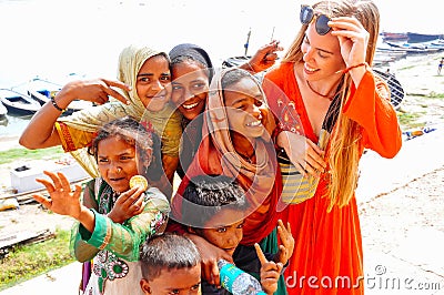 Locals embrace a tourist in Varanasi, India. Editorial Stock Photo