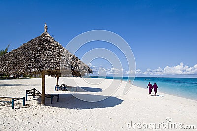 Locals walking on beach in zanzibar Stock Photo