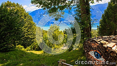 View of Locarno from Cardada with an eye drew on a pile of woods Stock Photo