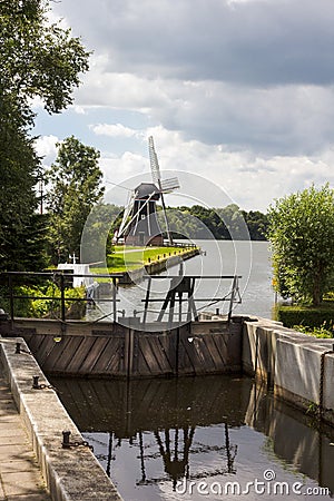 Lock gates and Dutch windmill Stock Photo