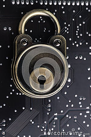 Lock pad on dark black computer circuit board with solder, safety and security, data encryption concept or technology to encode o Stock Photo