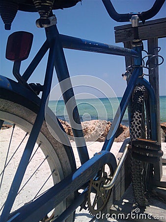 A Blue Bike Facing the Blue Sea Stock Photo
