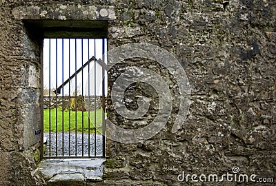 Locked gate in old stone wall Stock Photo