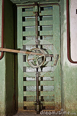 Locked from inside rusty hermetical door of old abandoned Soviet Stock Photo