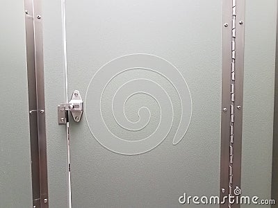 Locked or latched bathroom or restroom stall door Stock Photo