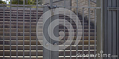 Locked metal gate and stairs on a sunny day Stock Photo