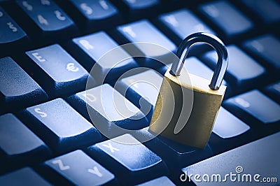 Locked metal padlock on blue computer keyboard. Data and password protection, internet and network security concept Stock Photo