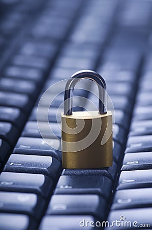 Locked metal padlock on blue computer keyboard. Data and password protection, internet and network security concept Stock Photo