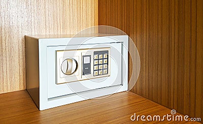 Locked metal security safes inside wooden cupboard Stock Photo