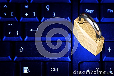 Locked padlock on a black computer keyboard Stock Photo