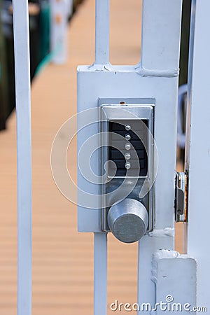 Locked private security gate door with pushbutton combination lock system Stock Photo