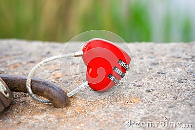 Locked red heart shaped combination lock Stock Photo