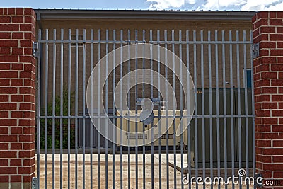 A locked security gate industrial machines and building Stock Photo